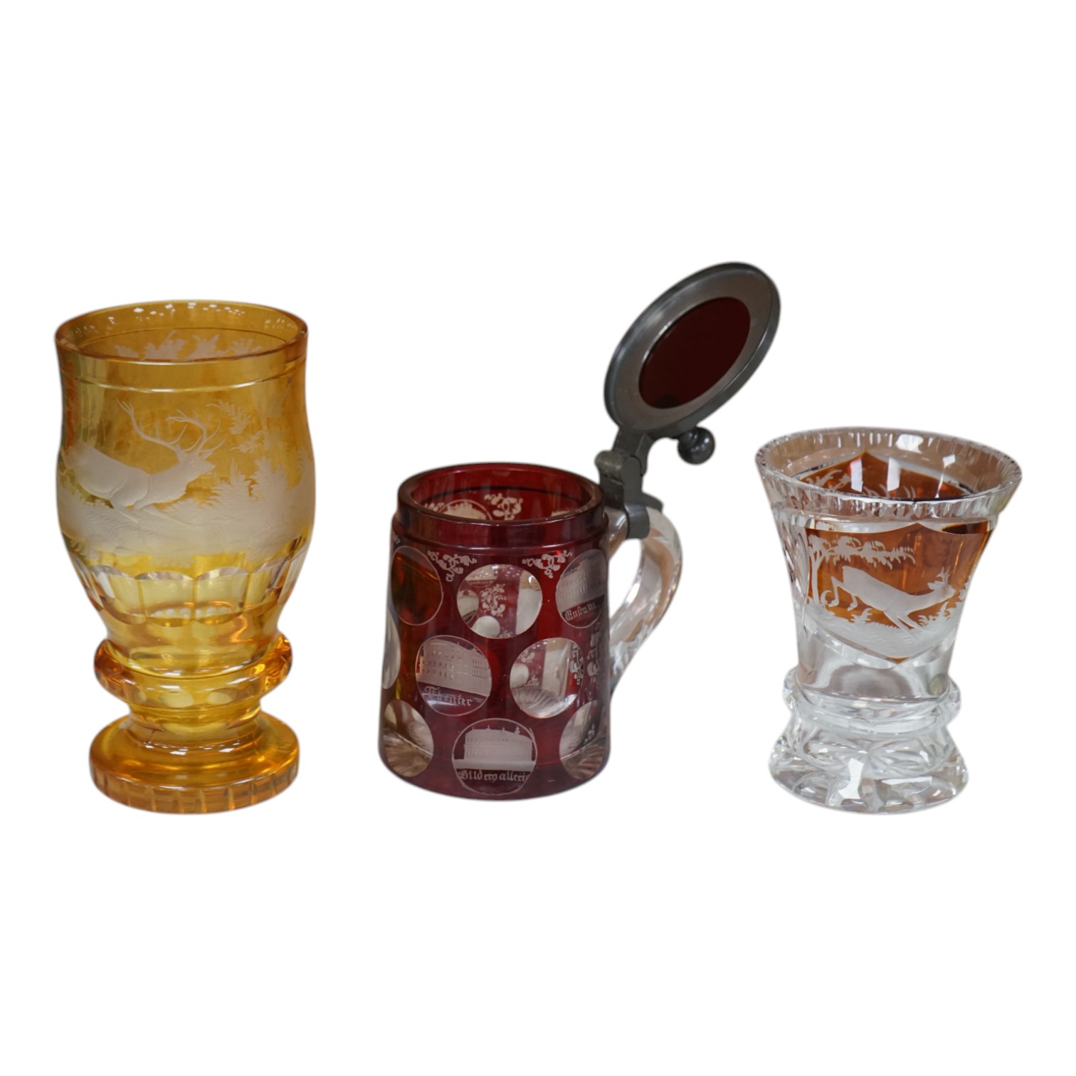 Two 19th century Bohemian glasses and a similar tankard, amber glass 15cm high. Condition - good